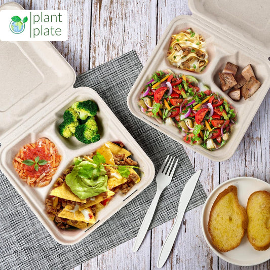 Various plant-based meal boxes with plates, cutlery, and bowls for a healthy diet